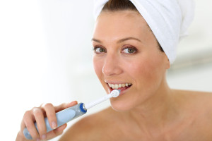 woman-brushing-teeth-in-towel
